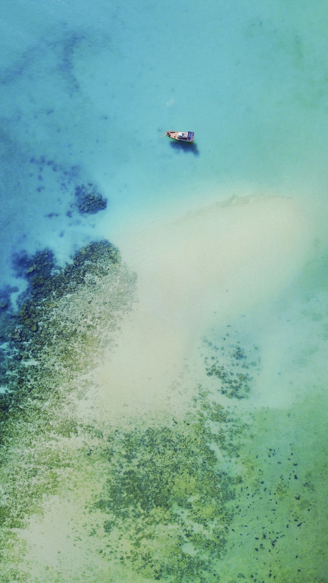 Tranquil Turquoise: A Solitary Boat's Voyage