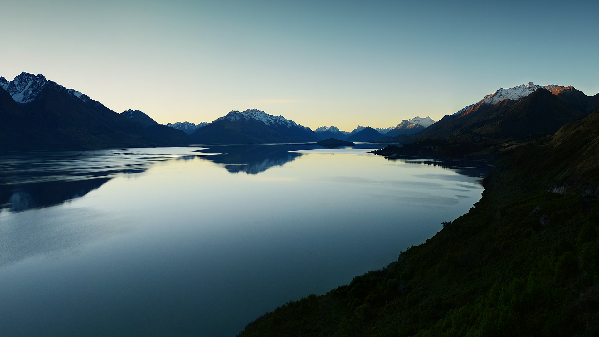 Tranquil Reflections: A Mountain Lake at Dusk
