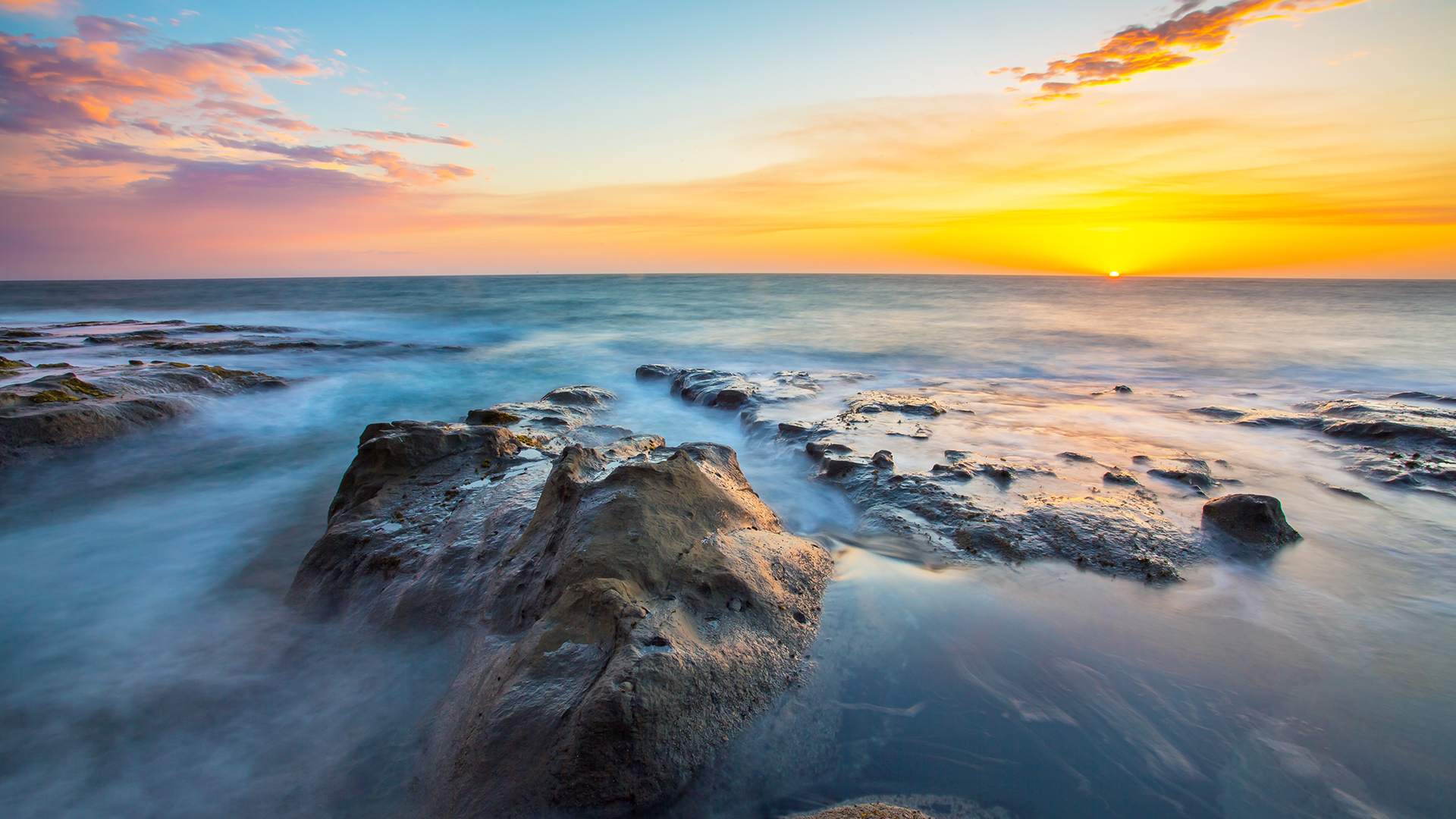 Tranquil Sunset at the Rocky Shore